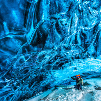 Tourist discovering the ice cave